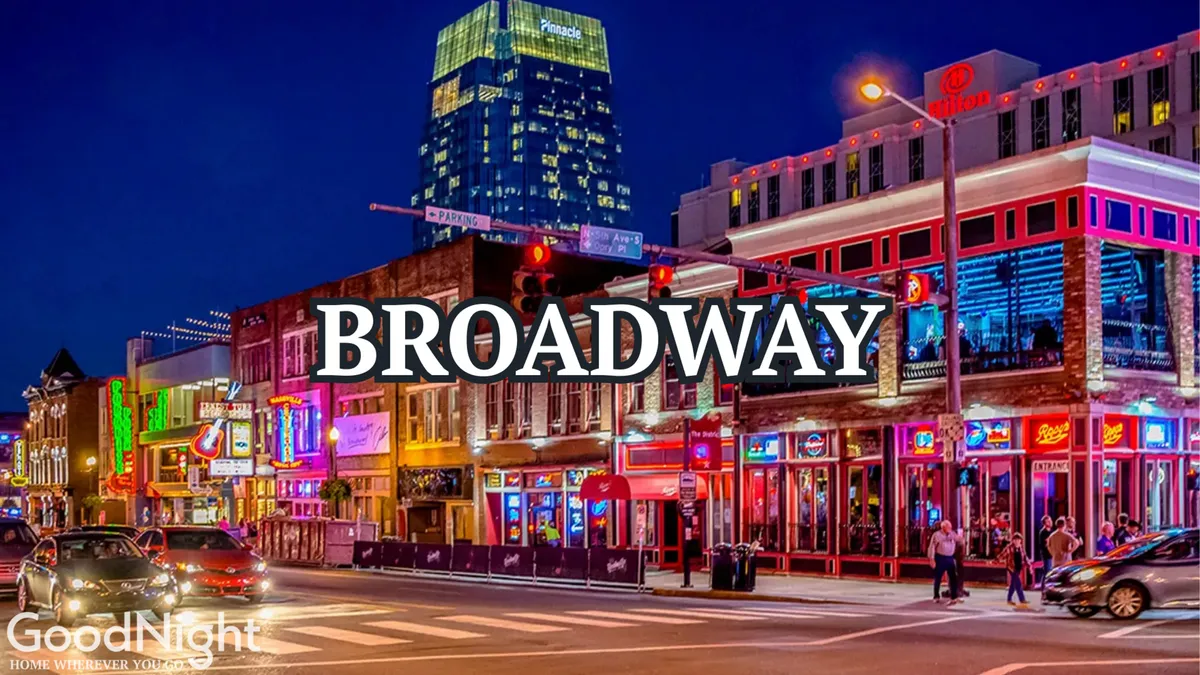 A lively exterior scene featuring neon signs, a bustling street, illuminated buildings, and a crowd of people enjoying a vibrant night out in Nashville. The energetic atmosphere is palpable, capturing the city's renowned nightlife and entertainment culture.